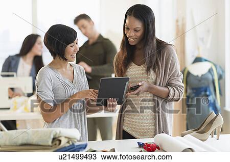 Stock Image - People working in fashion studio. Fotosearch