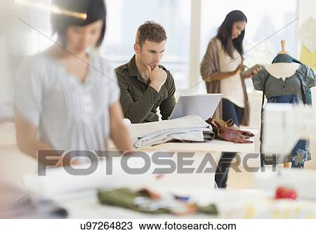 People working in fashion studio View Large Photo Image Stock Image - People working in fashion studio. Fotosearch