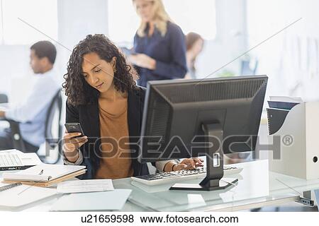 Stock Photo - People working in office. Fotosearch