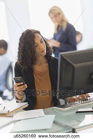 Stock Photo - People working in office. Fotosearch