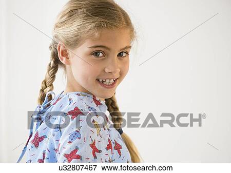Stock Photo - Portrait of blond girl (8-9) in hospital. Fotosearch