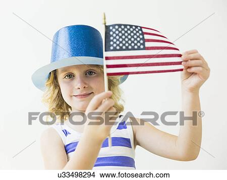 Picture - Portrait of blonde girl (4-5) holding American flag. Fotosearch
