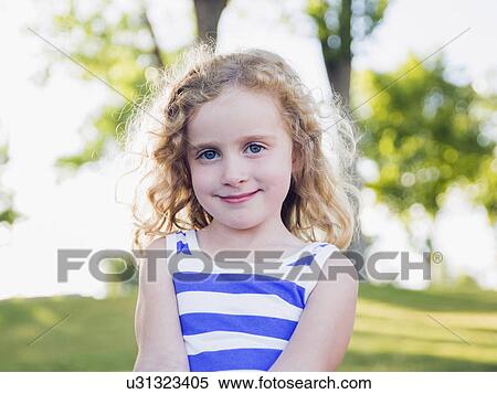 Stock Photography - Portrait of blonde girl (4-5) outdoors. Fotosearch