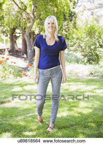 Portrait of blonde woman in park View Large Photo Image Picture - Portrait of blonde woman in park. Fotosearch