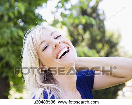 Portrait of blonde woman in park View Large Photo Image Stock Photograph - Portrait of blonde woman in park. Fotosearch
