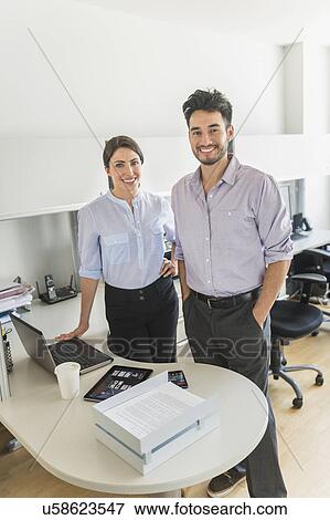 Portrait of businessman and businesswoman in office View Large Photo Image Stock Photo - Portrait of businessman and businesswoman in office. Fotosearch