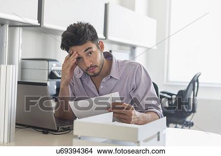 Portrait of businessman at work in office View Large Photo Image Picture - Portrait of businessman at work in office. Fotosearch