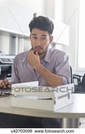 Portrait of businessman at work in office View Large Photo Image Stock Photo - Portrait of businessman at work in office. Fotosearch