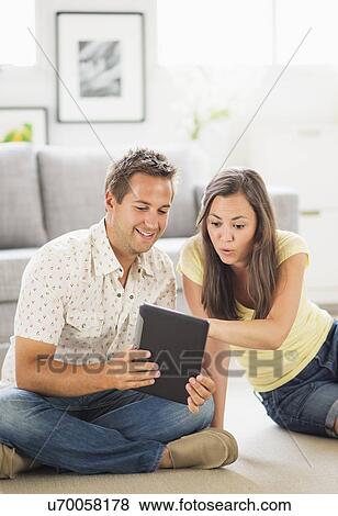 Stock Photo - Portrait of couple using digital tablet . Fotosearch