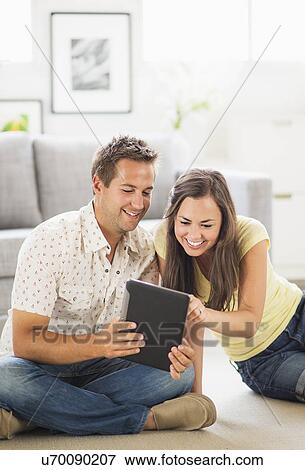 Portrait of couple using digital tablet View Large Photo Image Stock Photo - Portrait of couple using digital tablet . Fotosearch
