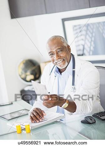 Portrait of doctor holding prescription View Large Photo Image Stock Image - Portrait of doctor holding prescription. Fotosearch