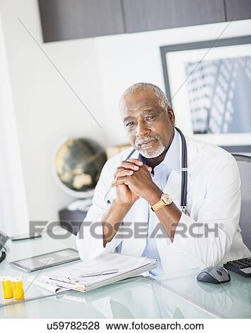 Portrait of doctor in office View Large Photo Image Stock Photo - Portrait of doctor in office. Fotosearch