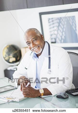 Portrait of doctor writing prescription View Large Photo Image Stock Image - Portrait of doctor writing prescription. Fotosearch