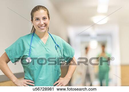 Portrait of female doctor in hospital hallway View Large Photo Image Stock Image - Portrait of female doctor in hospital hallway. Fotosearch