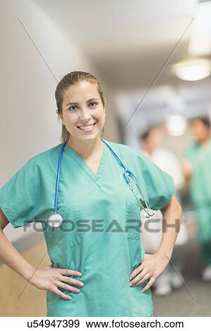Stock Photo - Portrait of female doctor in hospital hallway. Fotosearch