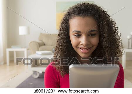 Portrait of girl (12-13) with digital tablet View Large Photo Image Stock Photo - Portrait of girl (12-13) with digital tablet. Fotosearch