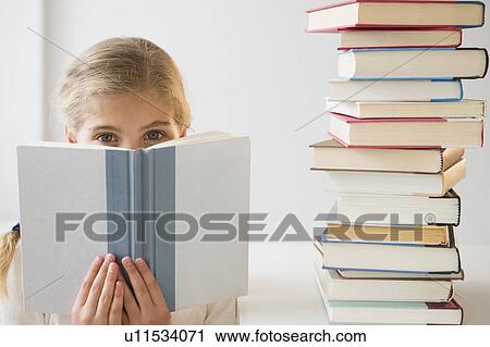 Portrait of girl (8-9) reading book View Large Photo Image Stock Image - Portrait of girl (8-9) reading book. Fotosearch