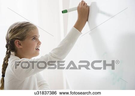 Portrait of girl (8-9) writing on white board View Large Photo Image Stock Photograph - Portrait of girl (8-9) writing on white board. Fotosearch
