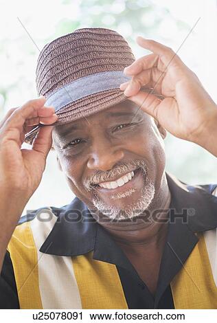Portrait of happy senior man wearing straw hat View Large Photo Image Stock Image - Portrait of happy senior man wearing straw hat. Fotosearch
