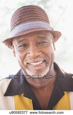 Portrait of happy senior man wearing straw hat View Large Photo Image Stock Photo - Portrait of happy senior man wearing straw hat. Fotosearch
