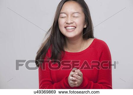 Stock Photo - Portrait of happy teenage girl (16-17) . Fotosearch