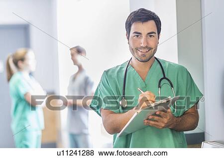 Portrait of male doctor in hospital hallway View Large Photo Image Stock Photo - Portrait of male doctor in hospital hallway. Fotosearch