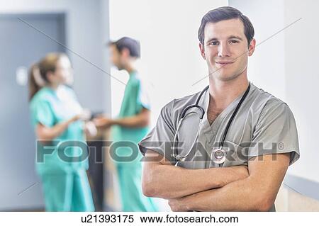 Stock Photography - Portrait of male doctor in hospital hallway. Fotosearch