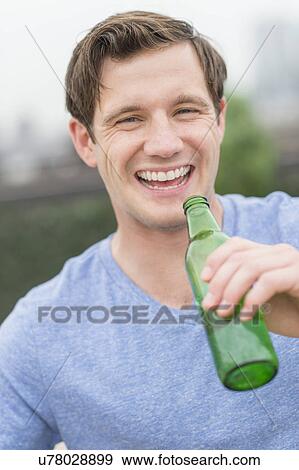 Stock Photo - Portrait of man drinking beer. Fotosearch