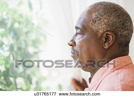 Portrait of man looking through window View Large Photo Image Stock Photo - Portrait of man looking through window. Fotosearch