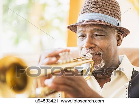 Portrait of man playing trumpet View Large Photo Image Stock Image - Portrait of man playing trumpet. Fotosearch
