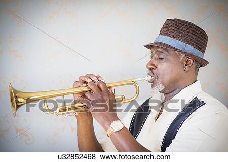 Portrait of man playing trumpet View Large Photo Image Stock Photo - Portrait of man playing trumpet. Fotosearch
