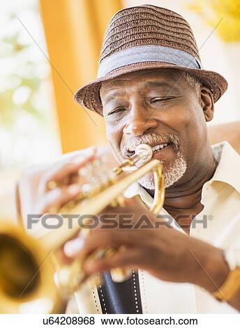 Portrait of man playing trumpet View Large Photo Image Stock Photo - Portrait of man playing trumpet. Fotosearch