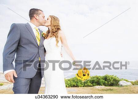 Stock Image - Portrait of married couple kissing. Fotosearch