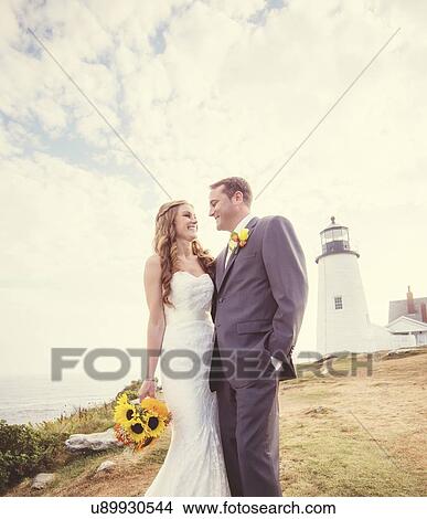 Picture - Portrait of married couple, lighthouse in background. Fotosearch