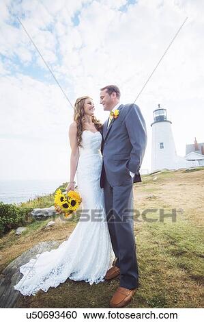 Portrait of married couple, lighthouse in background View Large Photo Image Stock Image - Portrait of married couple, lighthouse in background. Fotosearch
