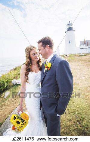 Stock Photograph - Portrait of married couple, lighthouse in background. Fotosearch