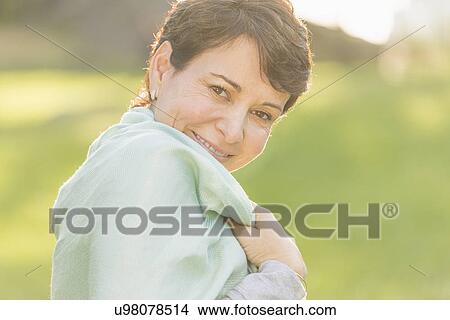 Picture - Portrait of mature woman smiling outdoors. Fotosearch