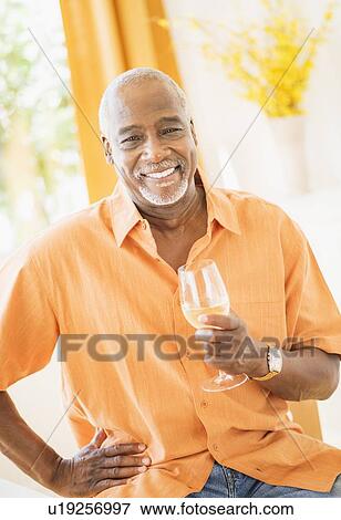 Portrait of men holding wine glass View Large Photo Image Stock Photo - Portrait of men holding wine glass. Fotosearch