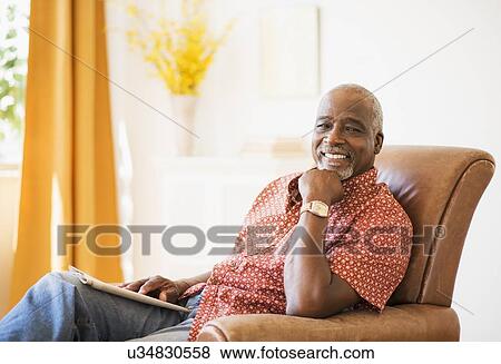 Portrait of men sitting in armchair View Large Photo Image Stock Photo - Portrait of men sitting in armchair. Fotosearch