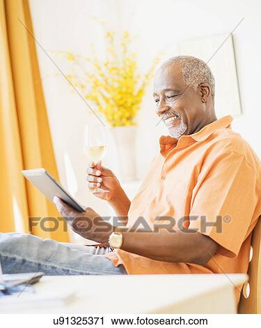 Portrait of men using digital tablet and holding wine glass View Large Photo Image Stock Image - Portrait of men using digital tablet and holding wine glass. Fotosearch