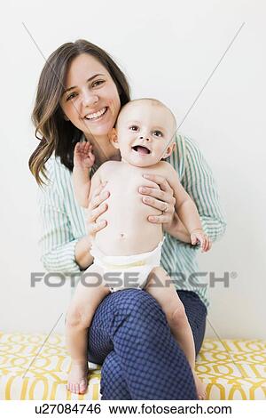 Stock Photograph - Portrait of mother with baby son (6-11 months). Fotosearch