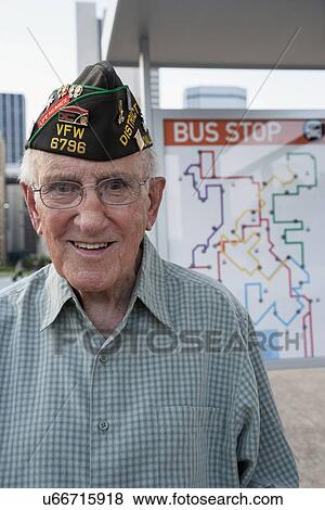 Stock Photo - Portrait of senior man standing at bus stop. Fotosearch