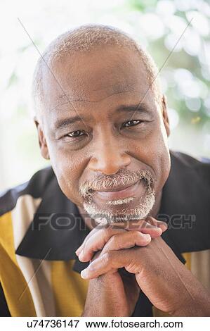 Portrait of senior man with hands clasped View Large Photo Image Stock Photo - Portrait of senior man with hands clasped. Fotosearch