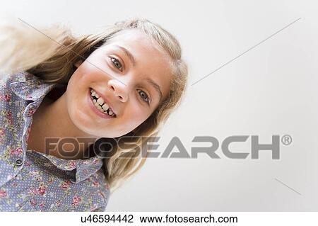 Stock Image - Portrait of smiling blonde girl (8-9). Fotosearch