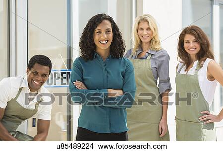 Portrait of smiling business owner with her workers View Large Photo Image Picture - Portrait of smiling business owner with her workers. Fotosearch