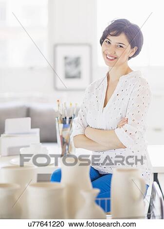 Portrait of smiling woman in art studio View Large Photo Image Stock Image - Portrait of smiling woman in art studio. Fotosearch