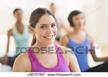 Portrait of smiling woman training yoga in gym View Large Photo Image Stock Image - Portrait of smiling woman training yoga in gym. Fotosearch