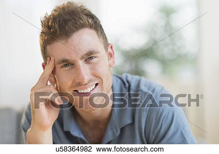 Portrait of smiling young man View Large Photo Image Stock Image - Portrait of smiling young man. Fotosearch