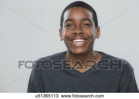 Stock Image - Portrait of teenage boy (14-15) smiling. Fotosearch