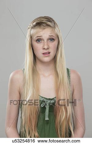 Portrait of teenage girl (14-15) making a face View Large Photo Image Stock Photograph - Portrait of teenage girl (14-15) making a face. Fotosearch
